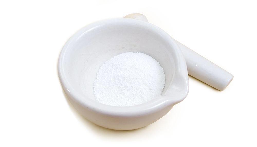 White mortar and pestle with L-arginine powder