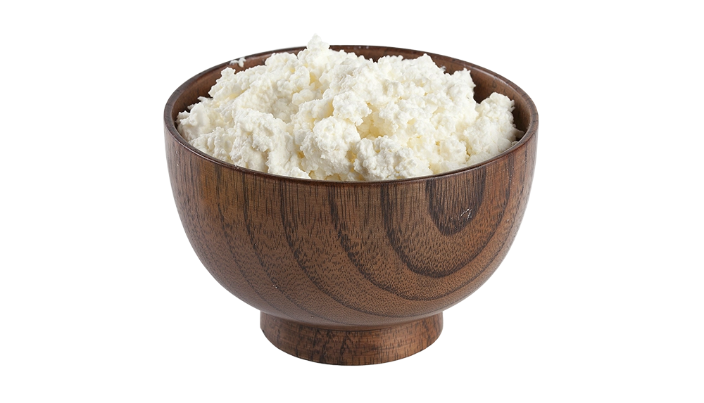 Wooden bowl of white probiotic powder